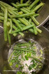 Adding Steamed Green Beans to Garlic and Green Onions